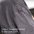 Close-up of the shoulder stitching and washed texture on a 230 GSM cotton T-shirt.