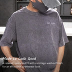 Charcoal washed cotton T-shirt worn with a small printed chest logo and relaxed fit.