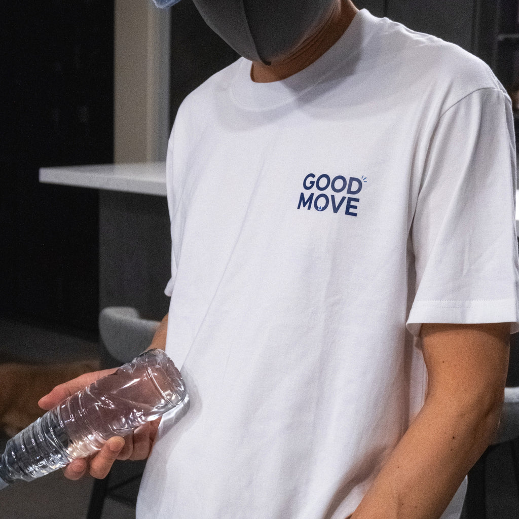 White custom cotton T-shirt worn with a small navy chest logo.
